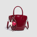 Women's mini bag with shiny surface and playful pendant