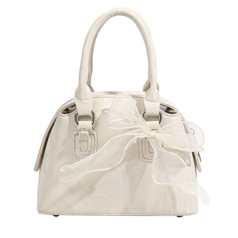Women’s mini handbag with playful bow accent