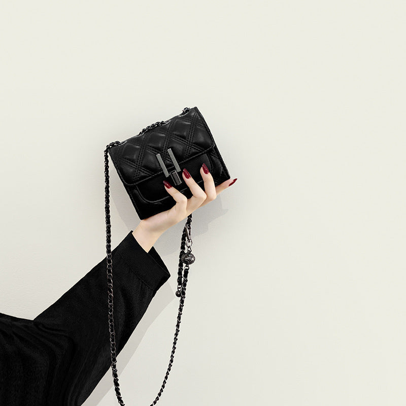 Women’s mini clutch with elegant chain strap and luxurious quilted pattern
