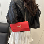 Women's elegant clutch in minimalist design with golden accents