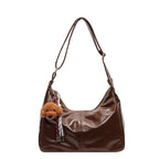 Shoulder bag with charming animal pendant