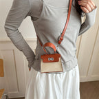 Ladies mini handbag with luxurious leather look and practical carrying handles