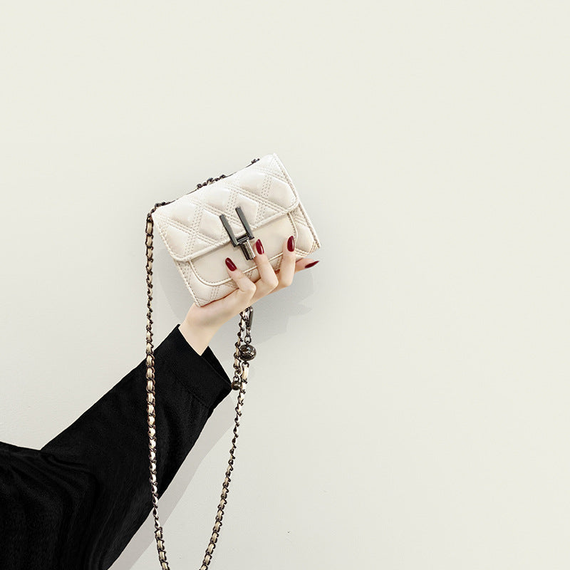Women’s mini clutch with elegant chain strap and luxurious quilted pattern