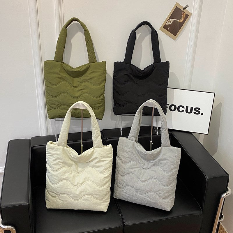 Padded shoulder bag with wave design
