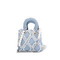 Women’s mini handbag with striking cinched design and pearl accents