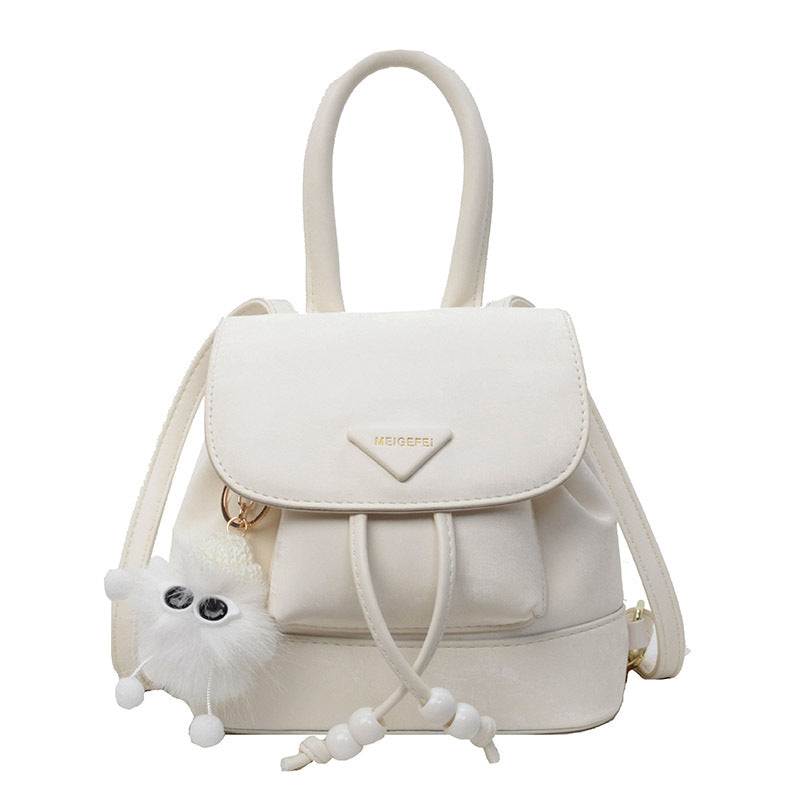 Women's mini backpack with playful design and plush pendant
