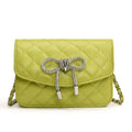 Ladies mini handbag with luxurious quilted pattern and sparkling chain pendant