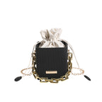 Women's mini handbag with unique chain embellishment and classic drawstring