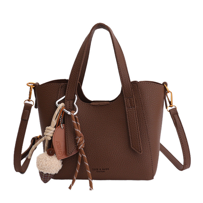 Women's mini handbag in an elegant design with charming pendant