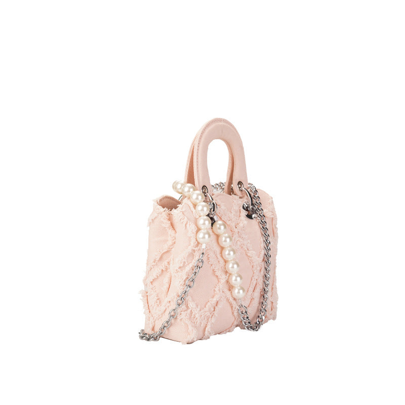 Women’s mini handbag with striking cinched design and pearl accents