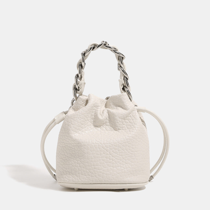Women's mini backpack bag with elegant chain handle and fine texture