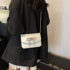 Ladies mini handbag with luxurious quilted pattern and sparkling chain pendant