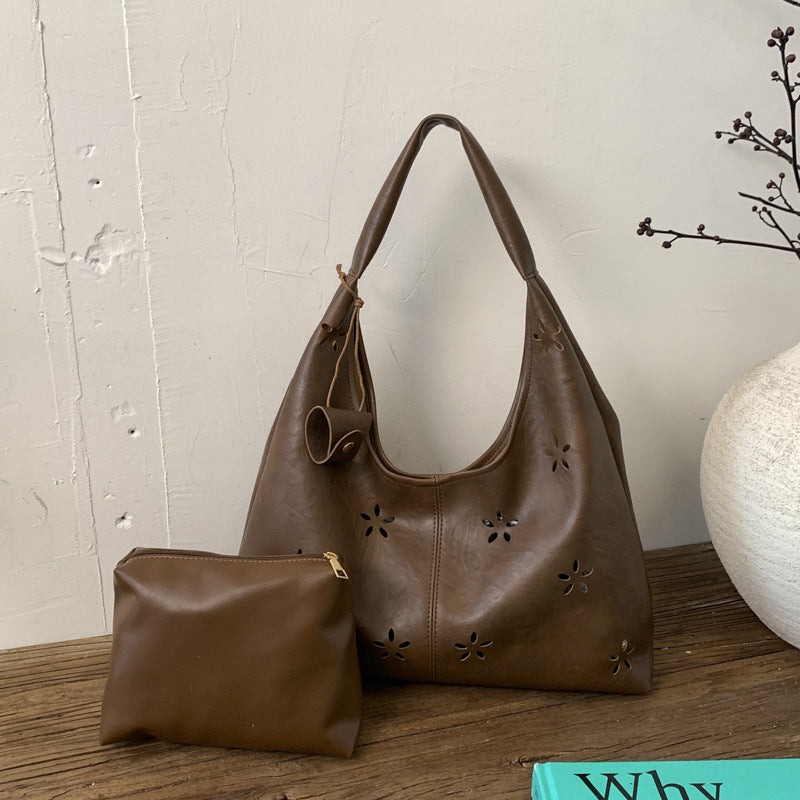 Women's hobo bag with floral design and practical mini organizer