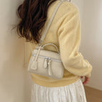 Women's mini handbag with fine decorative seams and detachable shoulder strap