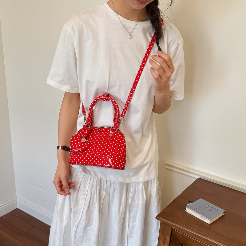 Women’s mini handbag with playful polka dot pattern and detachable shoulder strap