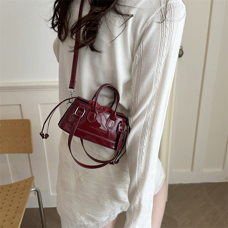 Women's mini bag with playful drawstring and shiny finish