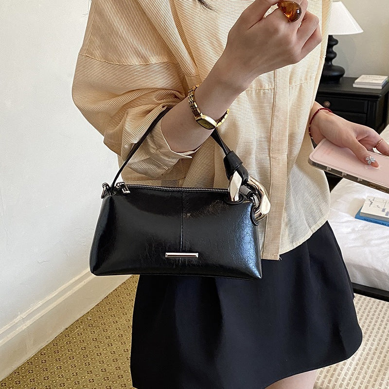Ladies elegant handbag with minimalist design and noble accents