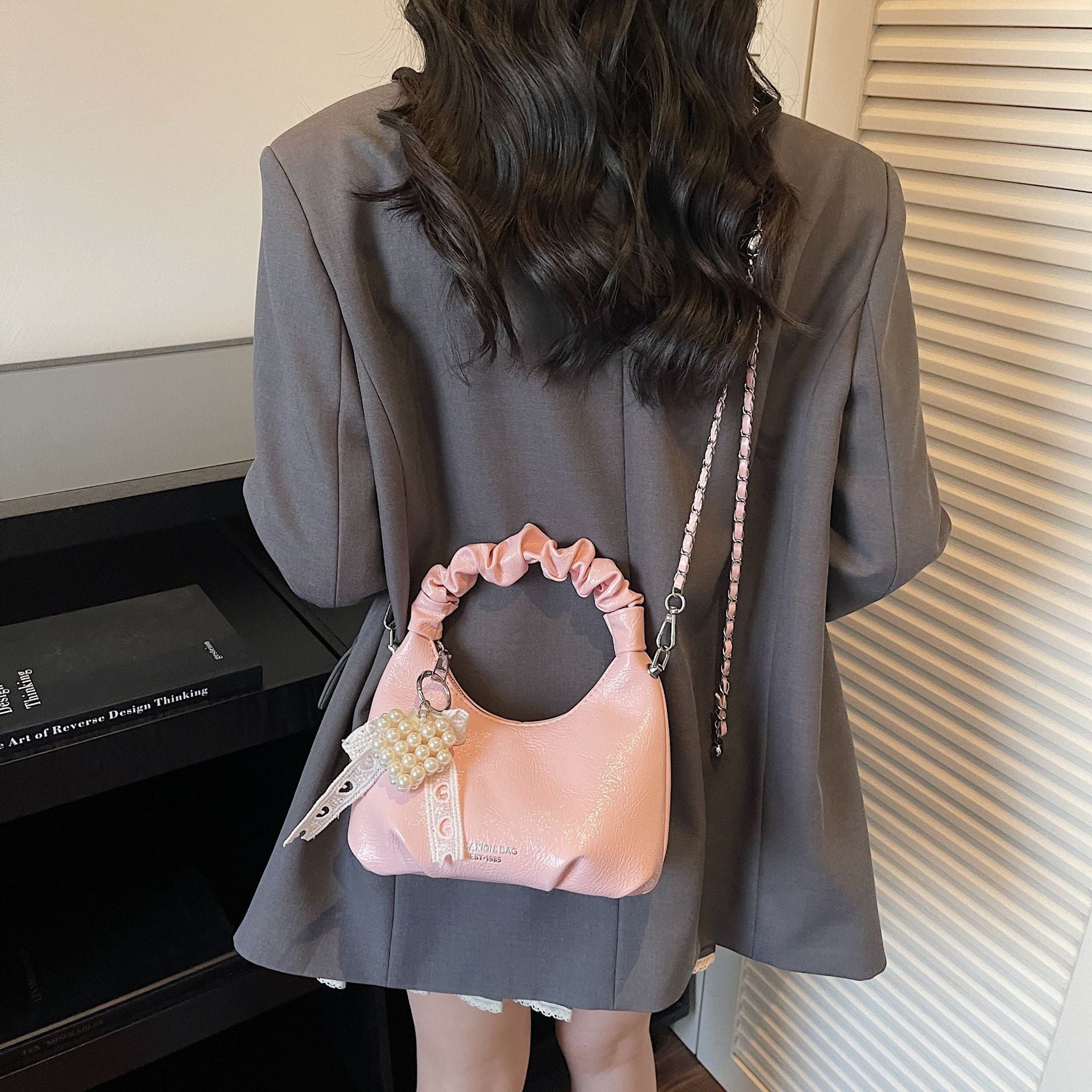 Ladies mini handbag with voluminous ruffle design and trendy charms