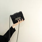 Women's clutch bag with elegant quilting and fine chain strap