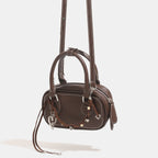 Women's mini handbag with playful drawstring and elegant accents