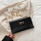 Women's elegant clutch in minimalist design with golden accents