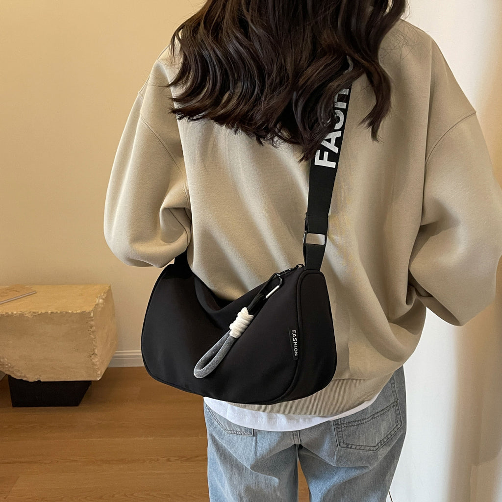 Fashionable shoulder bag with adjustable carrying strap