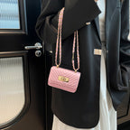 Women’s mini handbag with quilted design and golden clasp