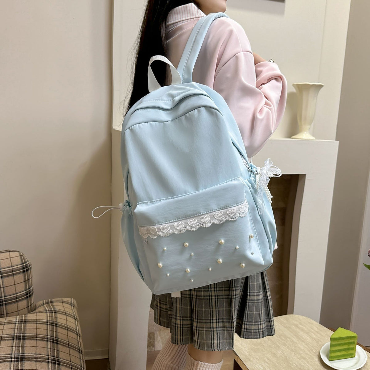 Backpack with elegant pearl applications and intricate design