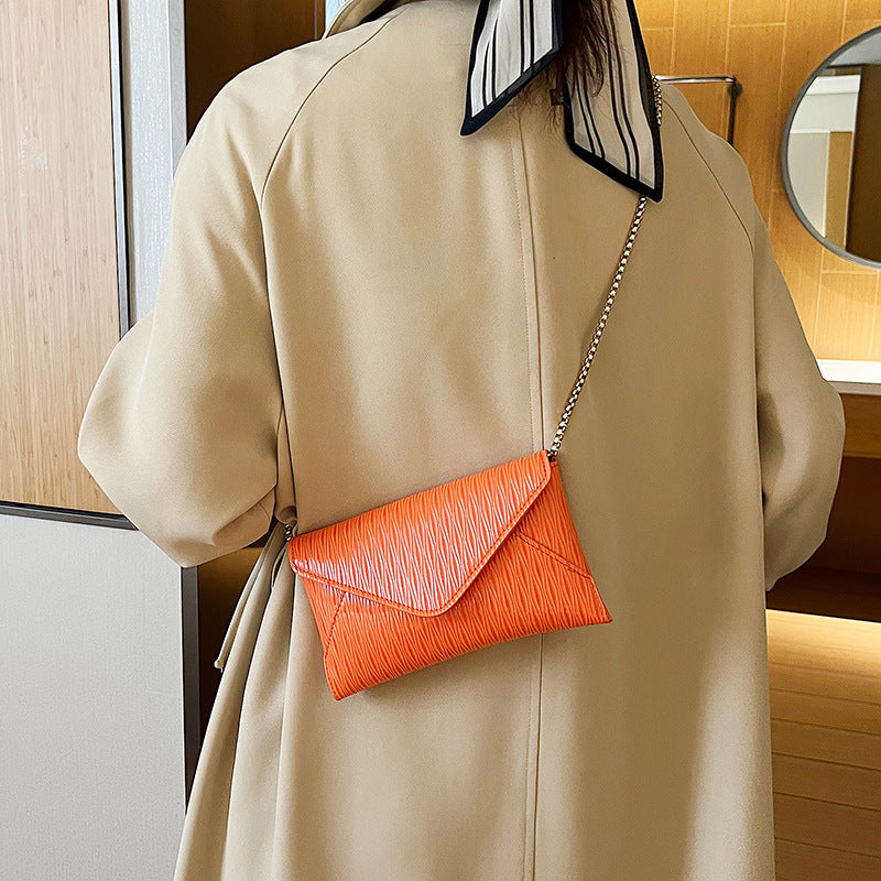Women's elegant clutch with shiny upper material