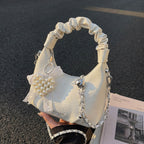 Ladies mini handbag with voluminous ruffle design and trendy charms