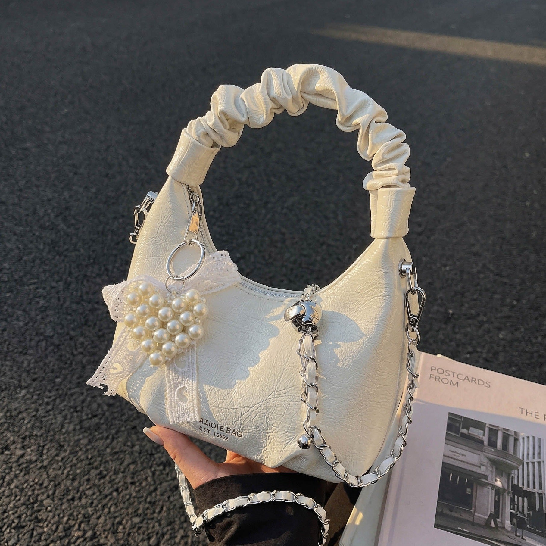 Ladies mini handbag with voluminous ruffle design and trendy charms