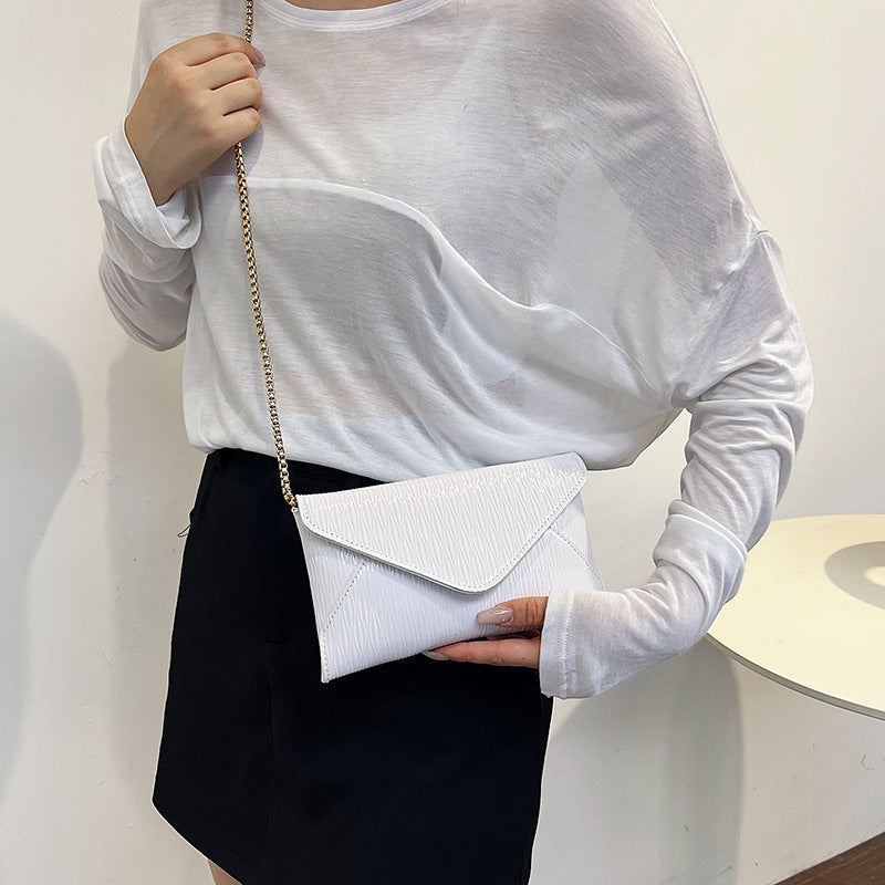 Women's elegant clutch with shiny upper material