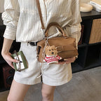 Women's mini handbag with charming animal pendant