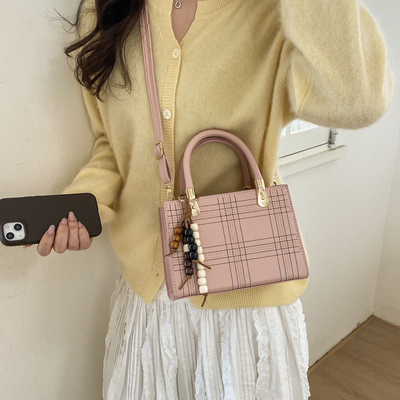 Women's mini handbag with elegant structure and golden accents
