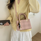 Women's mini handbag with elegant structure and golden accents