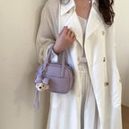 Women's mini handbag with playful animal charm
