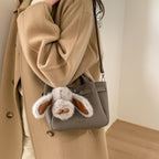 Women's mini handbag with playful design and animal charm