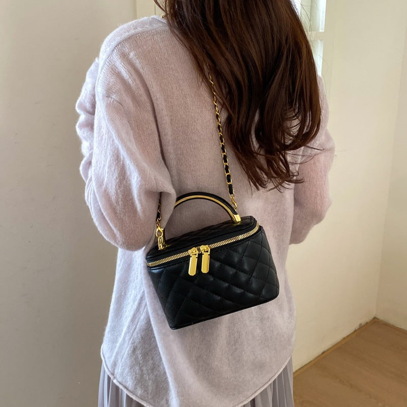 Women's mini handbag with gold chain accent and textured design