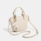 Women's mini handbag with playful animal charm