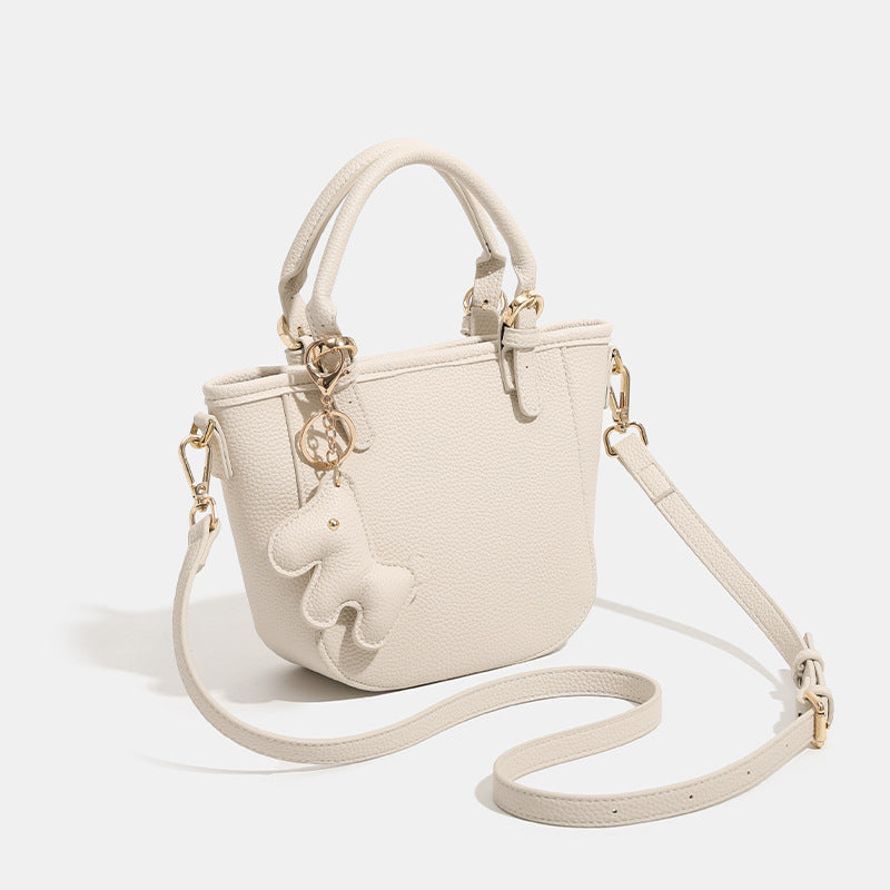 Women's mini handbag with playful animal charm