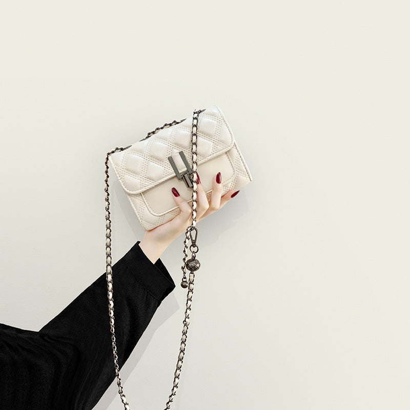 Women’s mini clutch with elegant chain strap and luxurious quilted pattern
