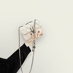 Women’s mini clutch with elegant chain strap and luxurious quilted pattern