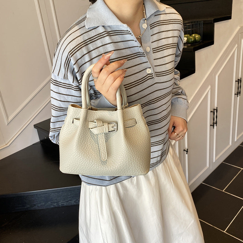 Women's mini handbag with stylish button closure