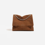Women's clutch bag made of shiny synthetic leather with decorative chain strap