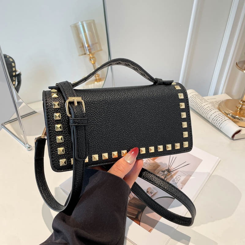 Women's mini handbag with sparkling upper material and golden studs