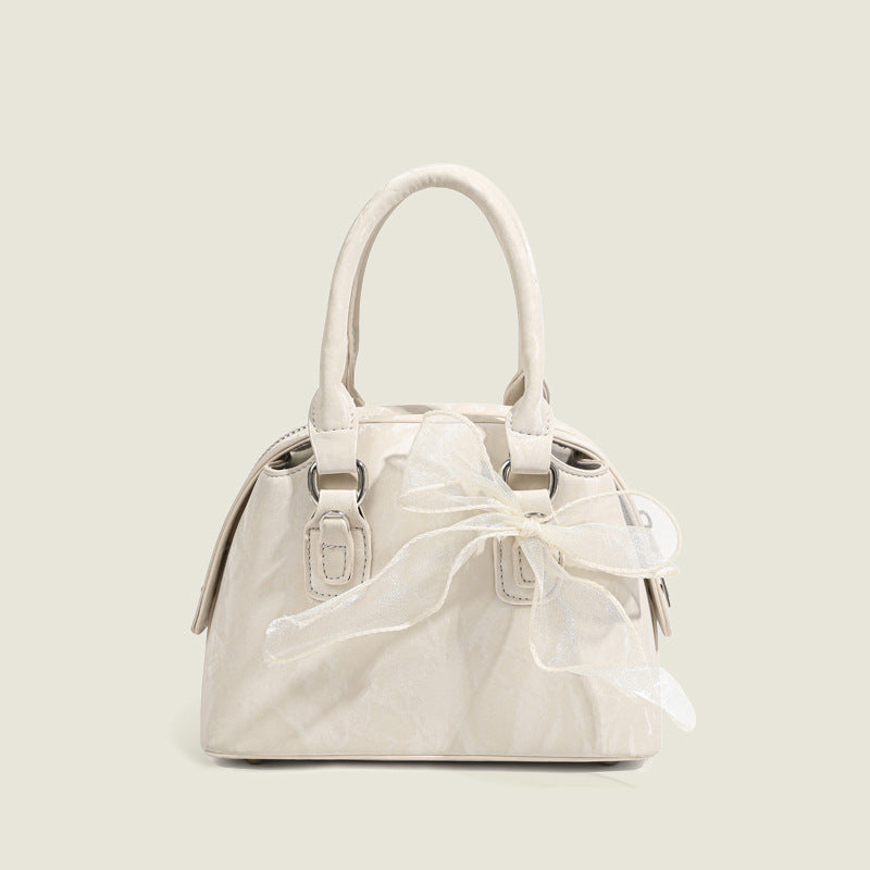Women’s mini handbag with playful bow accent