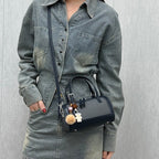 Women's mini bag with playful charm