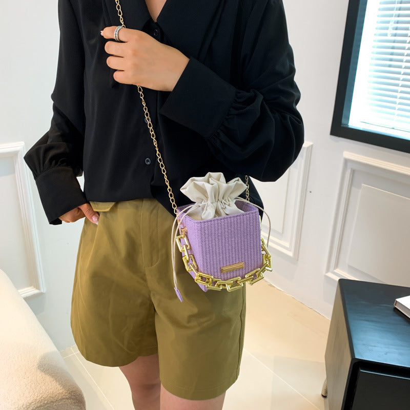 Women's mini handbag with unique chain embellishment and classic drawstring