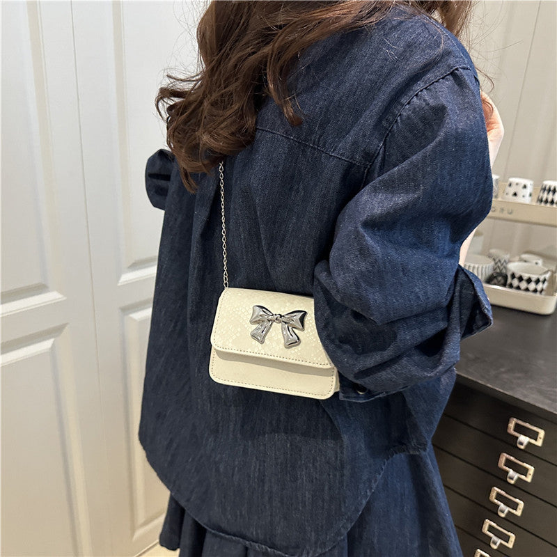 Women's clutch with playful bow design