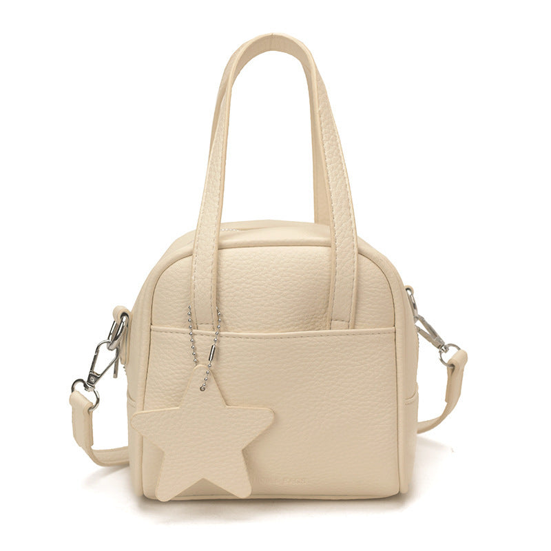 Ladies mini bag with decorative pendant